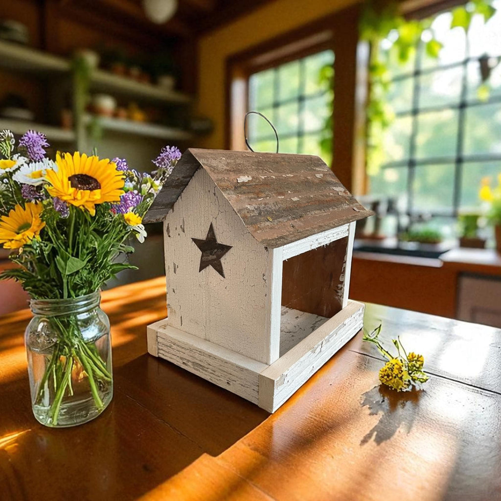 Rustic white wooden birdfeeder with a tin roof and star on both ends. Tray for easy feeding.